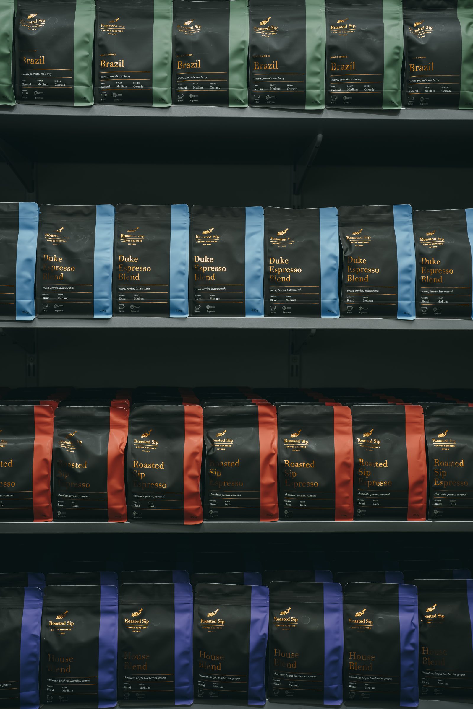 The Roasted Sip coffee lineup — bags on the shelf